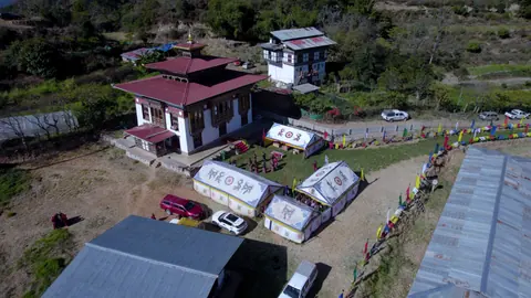 Aerial view of village buildings and a courtyard in Bhutan