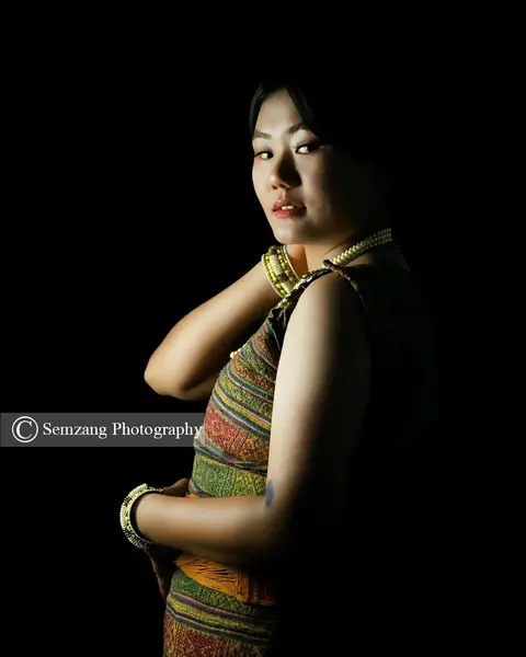 Low-key portrait of a woman in a traditional textile with jewellery