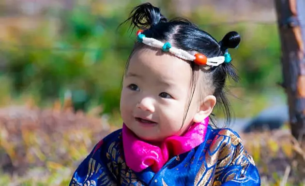 Smiling toddler in traditional dress