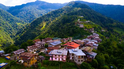 Aerial view of a mountain village with terraced homes